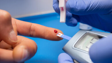 Closeup shot of a doctor with rubber gloves taking a blood test for cholesterol from a patient