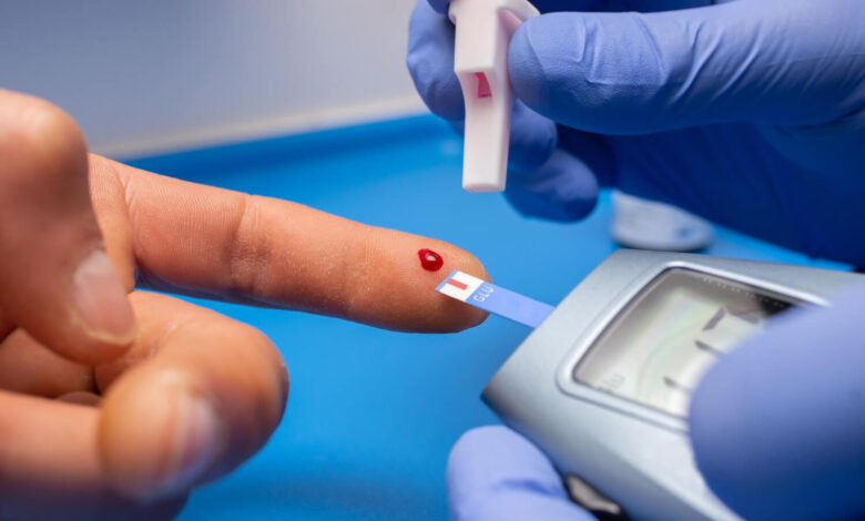 Closeup shot of a doctor with rubber gloves taking a blood test for cholesterol from a patient