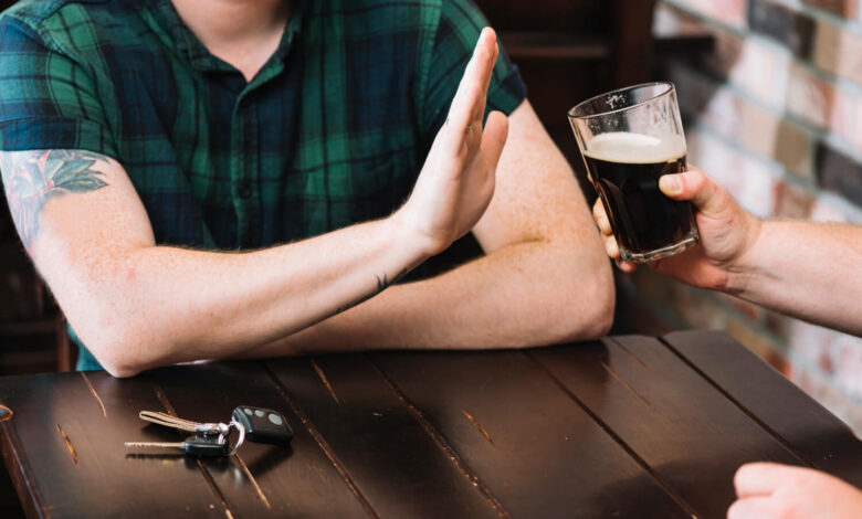 Image of a man refusing an alcoholic beverage - Why Reducing Alcohol Matters: Benefits and Strategies