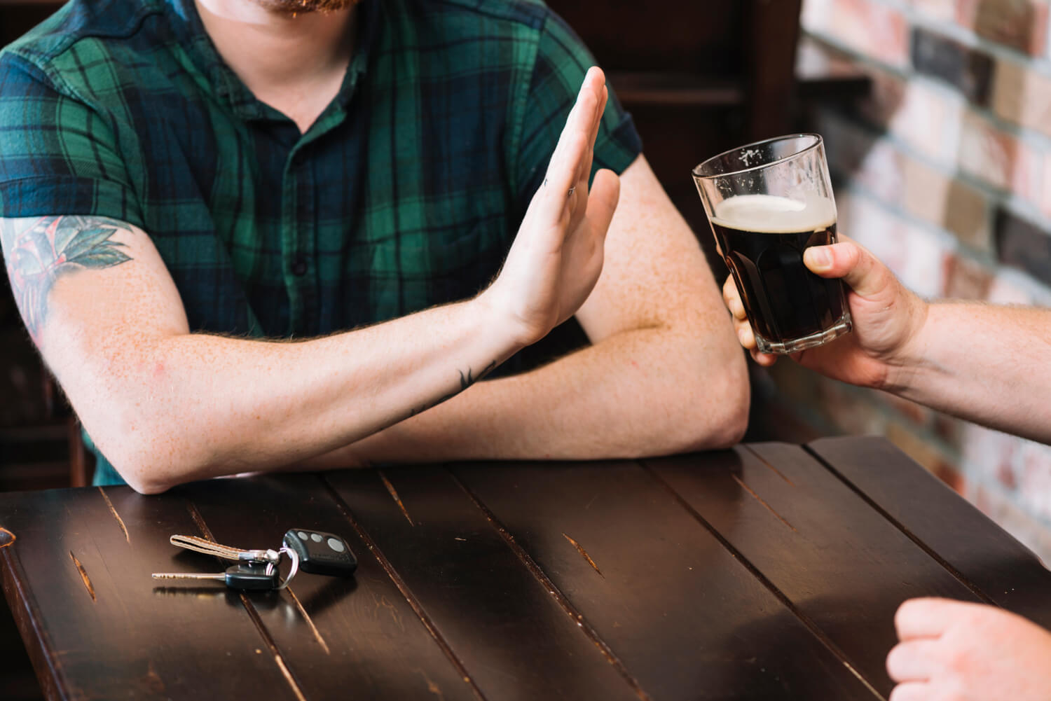 Image of a man refusing an alcoholic beverage - Why Reducing Alcohol Matters: Benefits and Strategies